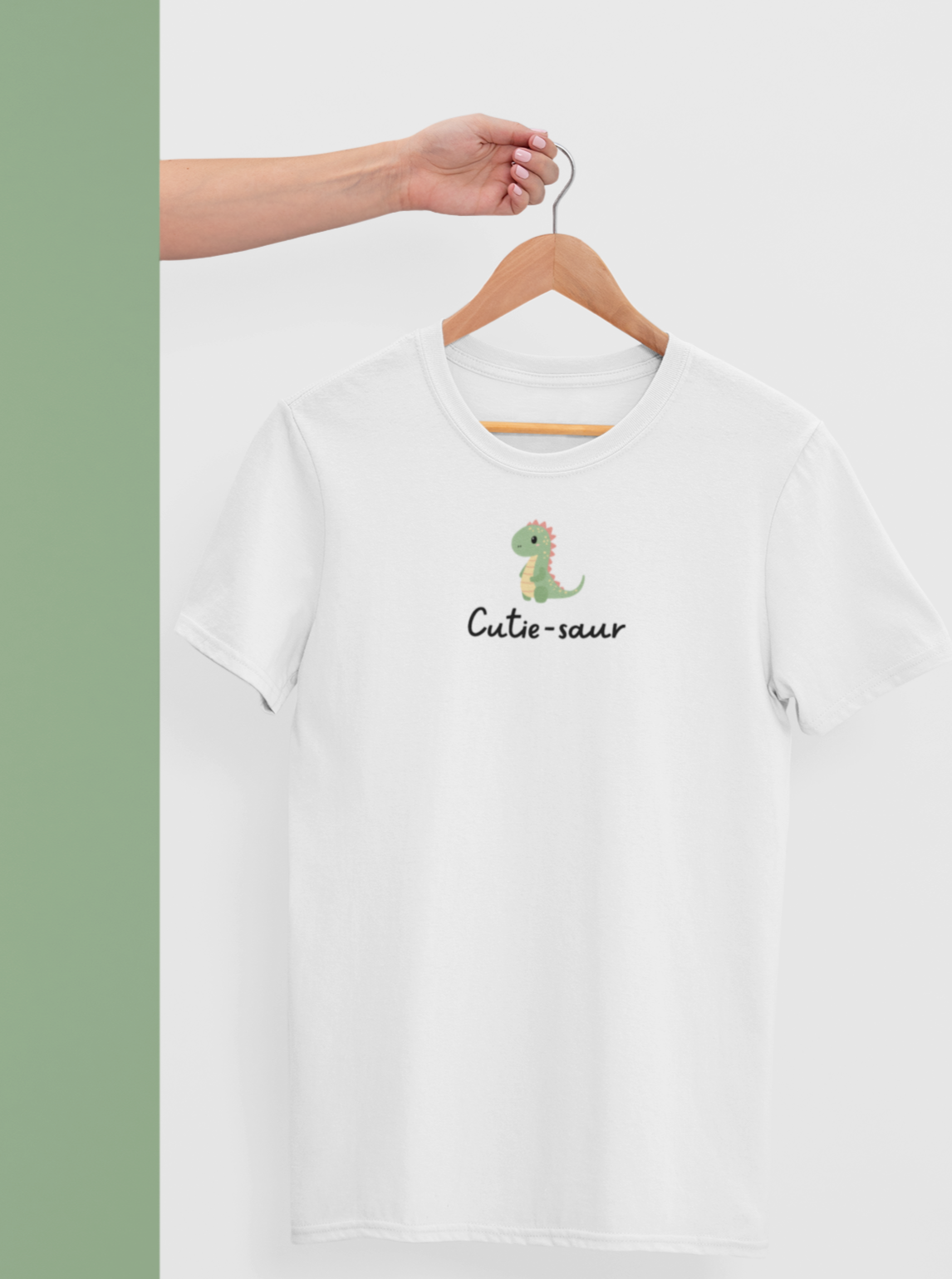 cute white tshirt with text 'cutie-saur' in black along with a cute little dinosaur